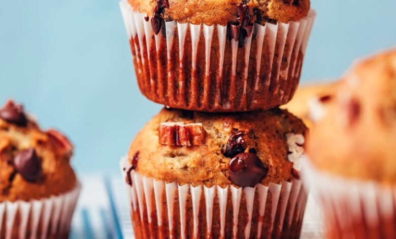 Stack of vegan gluten-free banana chocolate chip muffins dripping with melty chocolate