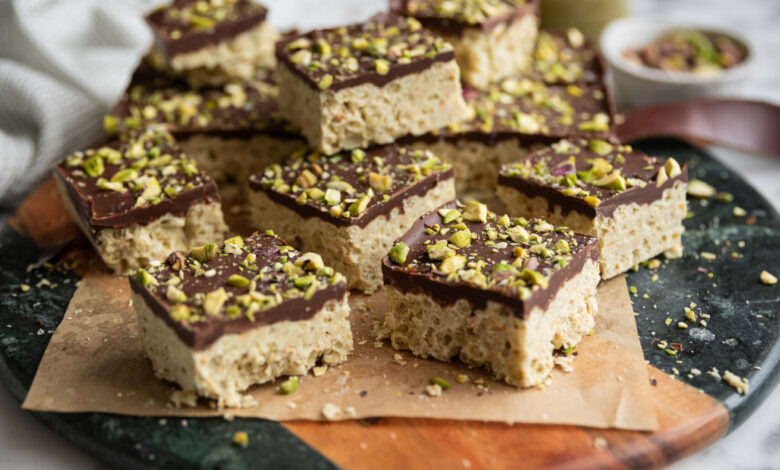 squares of Dubai Chocolate Rice Krispie treats with Pistachio on a board