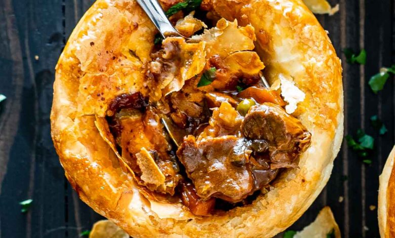 a fork inside a beef pot pie that was freshly baked.