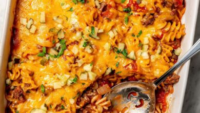 Overhead view of cheeseburger casserole in baking dish with serving spoon