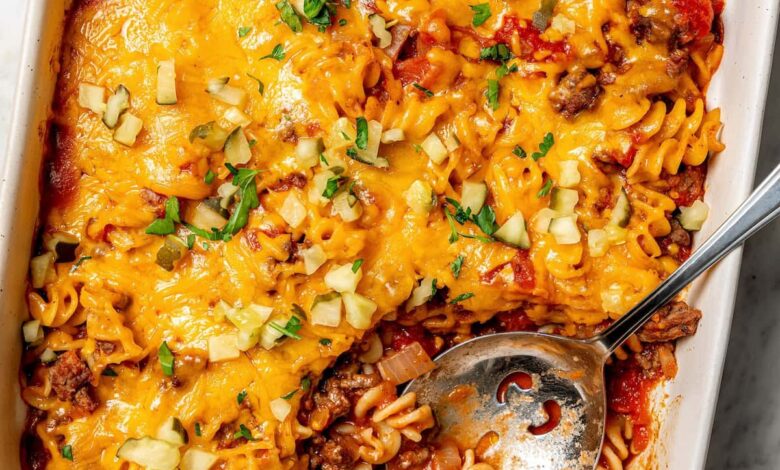 Overhead view of cheeseburger casserole in baking dish with serving spoon